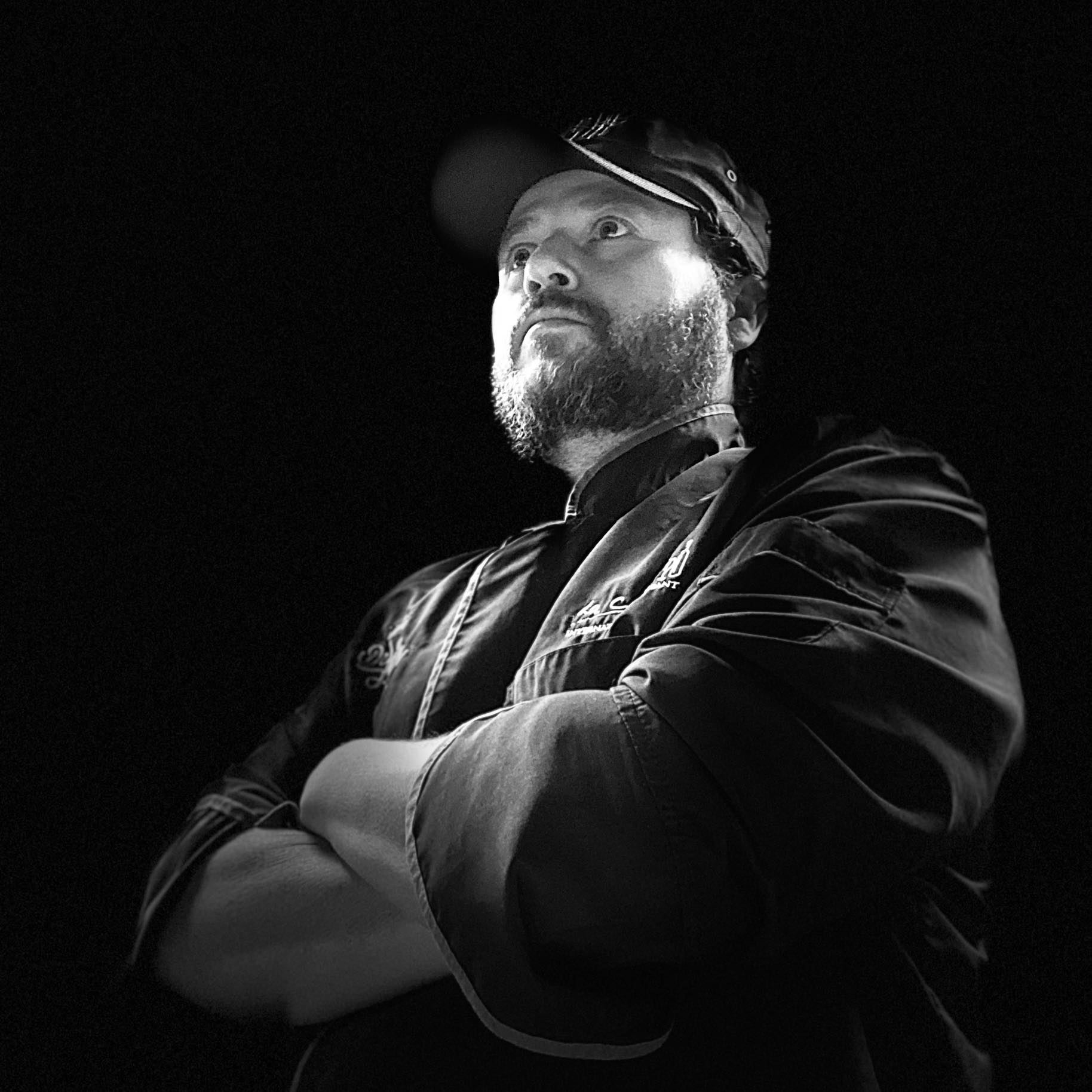 Chef J — dramatic B&W portrait, arms crossed