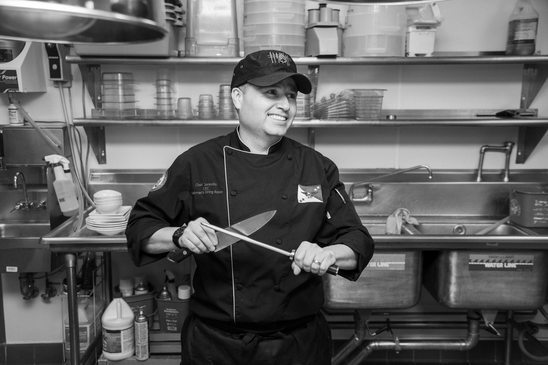 Chef J sharpening a knife in the kitchen
