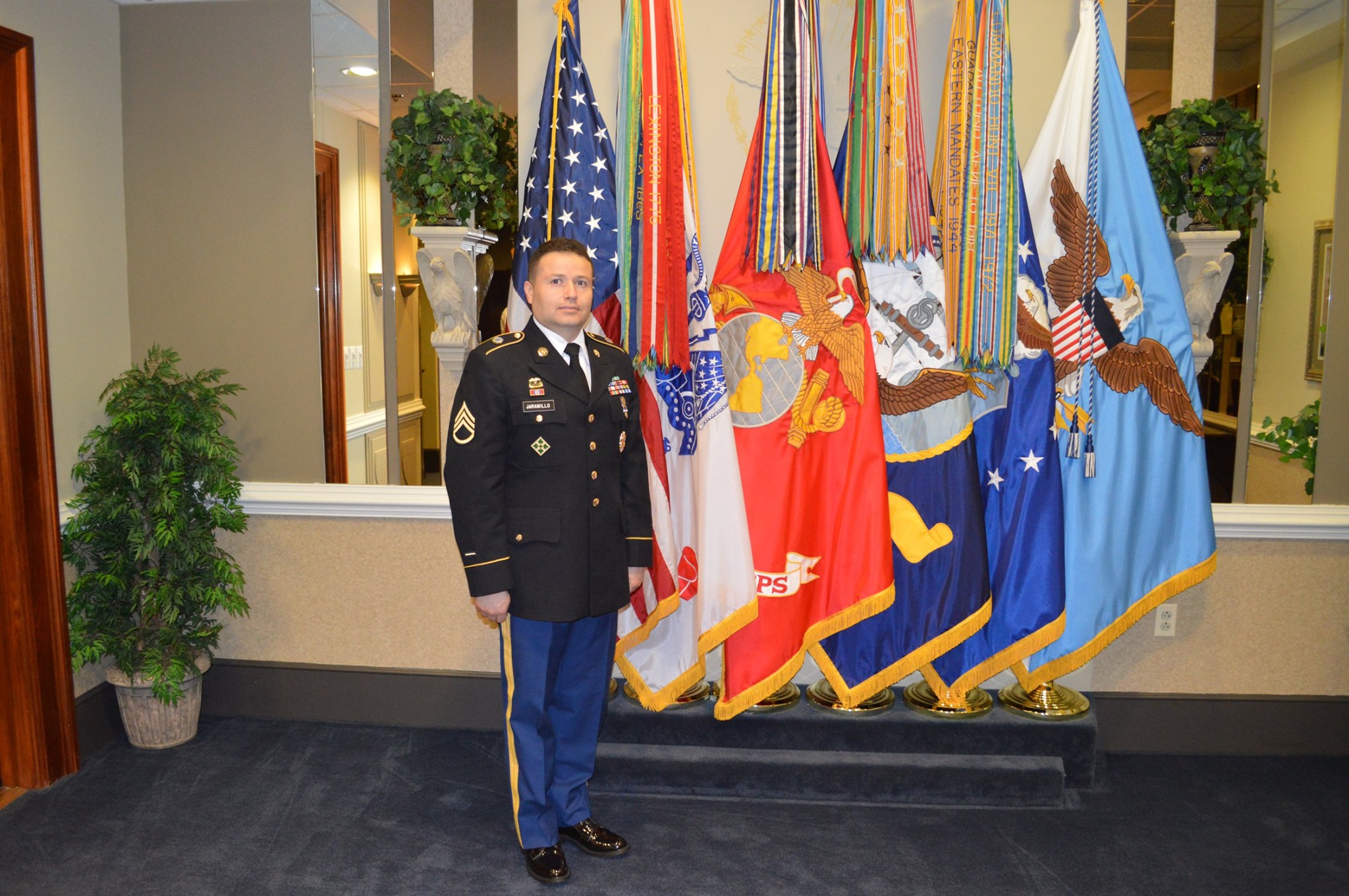 Francisco J. Jaramillo in Army dress uniform in front of flags